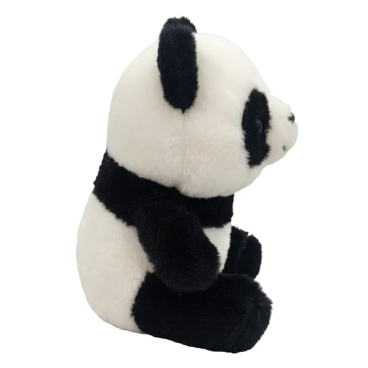 side view of small black and white panda soft toy with fluffy plush design