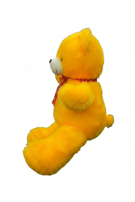 side view of 2ft yellow teddy bear soft toy with red bow and fluffy plush design