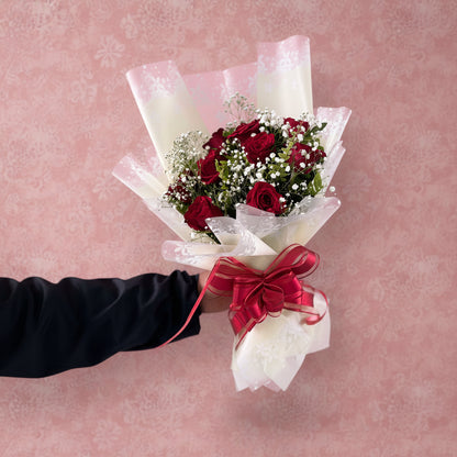 Fresh dozen red roses bouquet carefully wrapped for flower delivery in Nepal