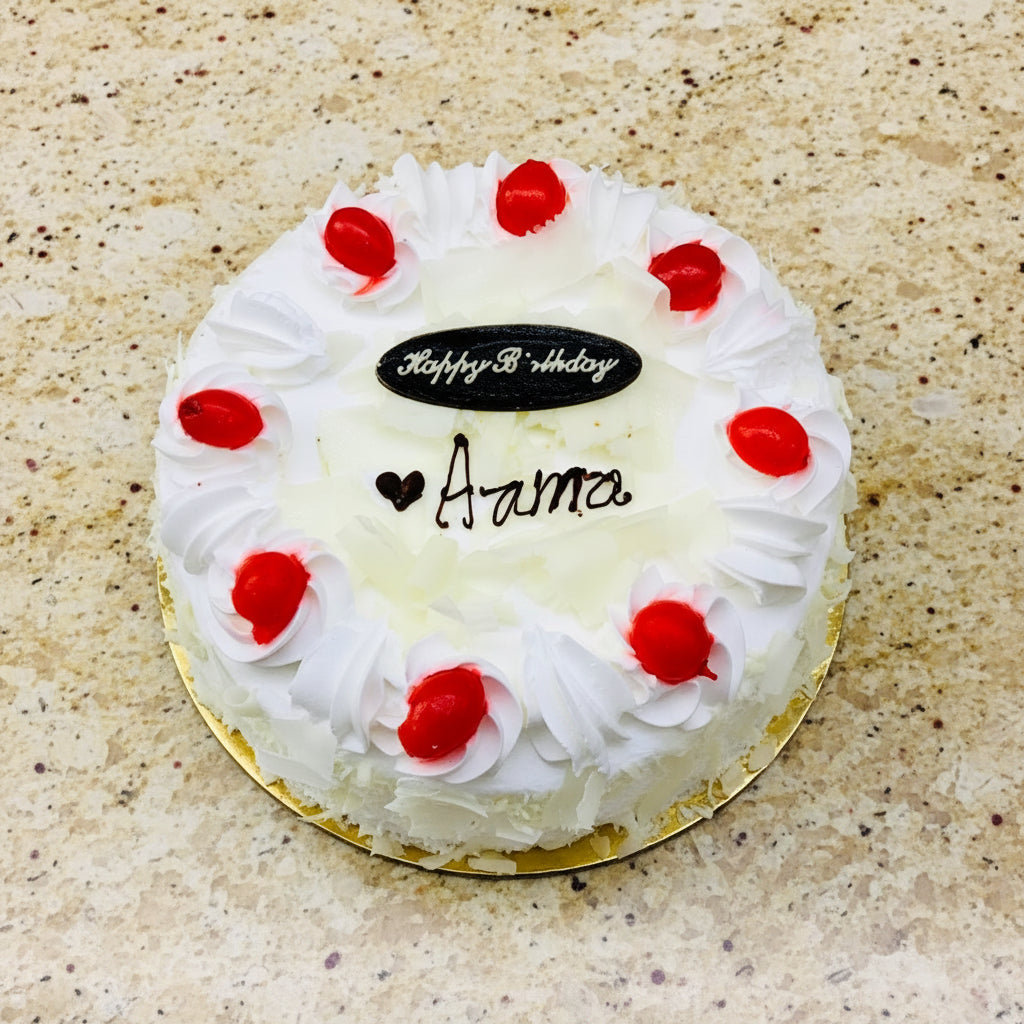Elegant White Forest Cake decorated with white chocolate and cherries available for online cake delivery in Kathmandu.